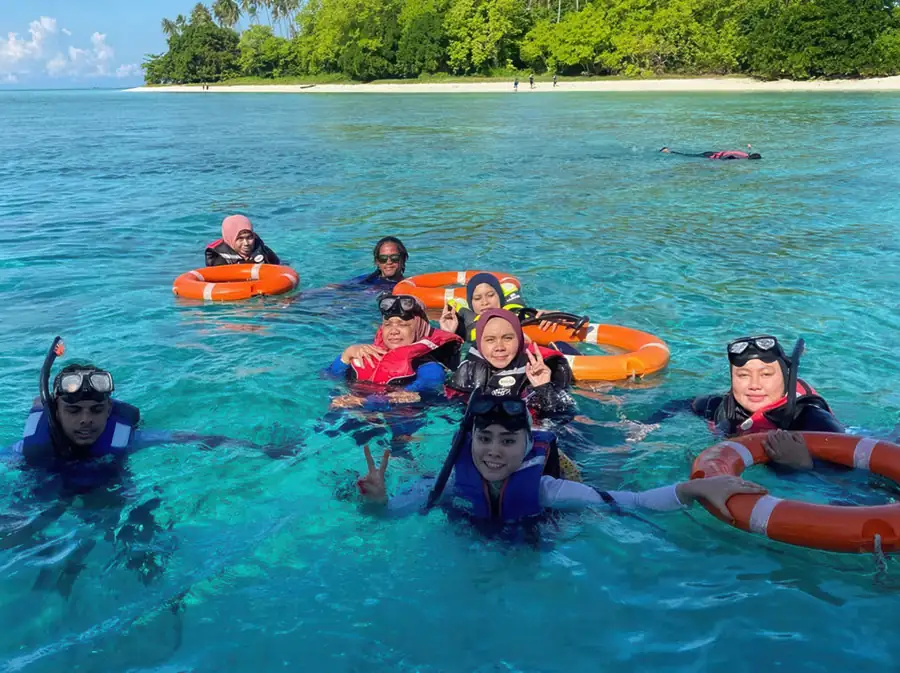 Snorkelling over coral reefs in the Celebes Sea near Blue Ocean Resort