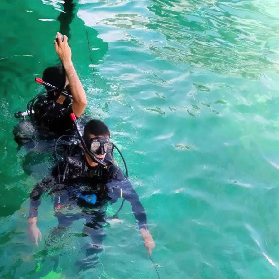 Scuba diver exploring coral reefs in the Semporna archipelago near Blue Ocean Resort